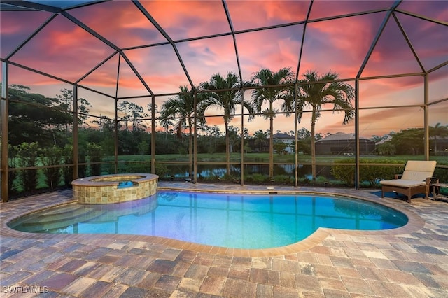 8331 Adelio Ln, Fort Myers, FL 33912 - pool at dusk with a pool with connected hot tub, a lanai, a patio area, and a water view
