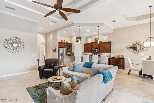 8331 Adelio Ln, Fort Myers, FL 33912 - living area with arched walkways, crown molding, light tile patterned flooring, recessed lighting, and a ceiling fan