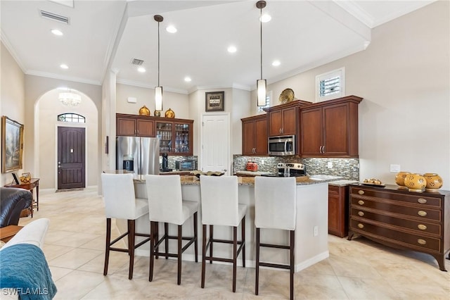 8331 Adelio Ln, Fort Myers, FL 33912 - kitchen with stainless steel appliances, light tile patterned floors, a breakfast bar, tasteful backsplash, and ornamental molding