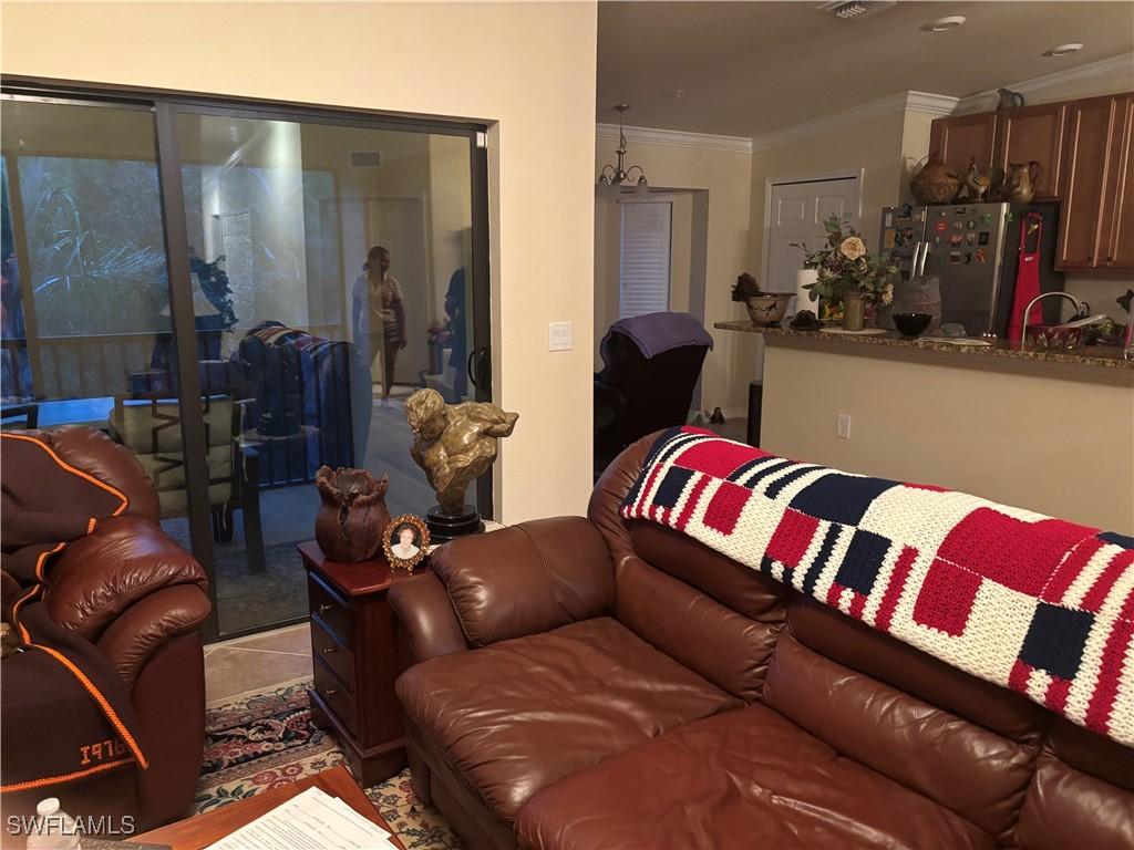 13761 Julias Way Unit 323, Fort Myers, FL 33919 - living area with crown molding