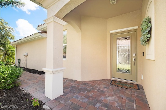 2042 Tamarron Ln, Naples, FL 34120 - doorway to property featuring stucco siding