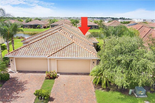 2042 Tamarron Ln, Naples, FL 34120 - view of front of home featuring a residential view, stucco siding, a tile roof, and a water view