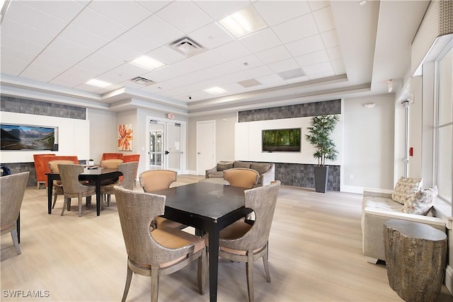 2042 Tamarron Ln, Naples, FL 34120 - dining space featuring a raised ceiling and light wood-type flooring