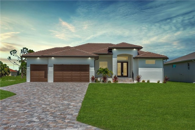 241 Rotonda Blvd S, Rotonda West, FL 33947 - mediterranean / spanish-style house with french doors, a garage, a front yard, decorative driveway, and stucco siding
