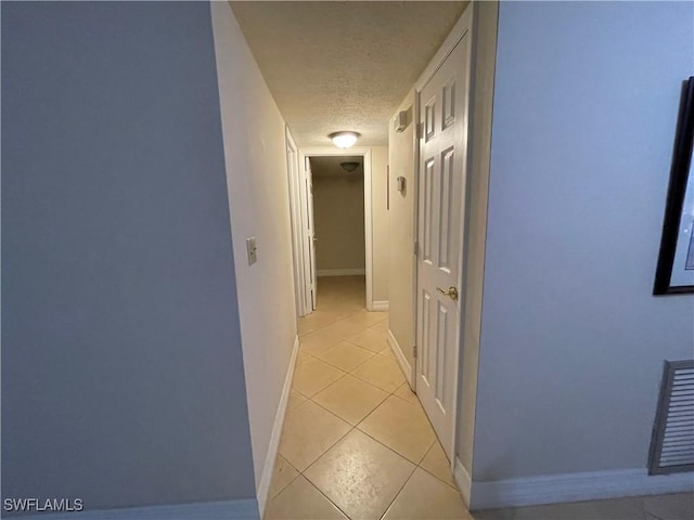1414 SE 46th St Unit 1C, Cape Coral, FL 33904 - hallway with light tile patterned floors and a textured ceiling