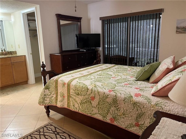 1414 SE 46th St Unit 1C, Cape Coral, FL 33904 - bedroom with light tile patterned flooring and connected bathroom