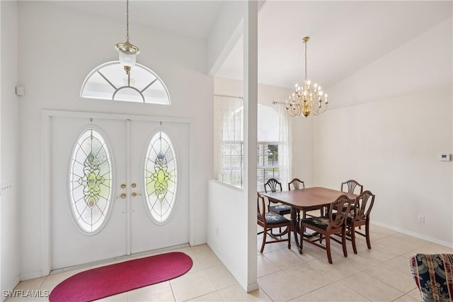 13671 Willow Bridge Dr, North Fort Myers, FL 33903 - foyer featuring healthy amount of natural light, a chandelier, vaulted ceiling, and light tile patterned floors