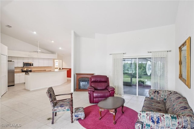13671 Willow Bridge Dr, North Fort Myers, FL 33903 - living area with high vaulted ceiling, light tile patterned floors, a glass covered fireplace, ceiling fan, and recessed lighting