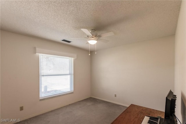 13611 Marquette Blvd, Fort Myers, FL 33905 - empty room featuring ceiling fan, carpet, and a textured ceiling