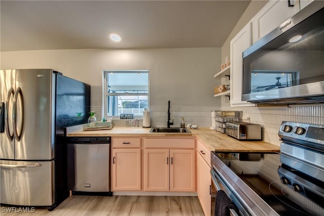 917 SW 23rd St, Cape Coral, FL 33991 - kitchen featuring appliances with stainless steel finishes, wood counters, light wood-style flooring, tasteful backsplash, and open shelves