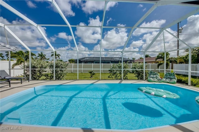 917 SW 23rd St, Cape Coral, FL 33991 - view of pool with glass enclosure, a fenced backyard, and a patio