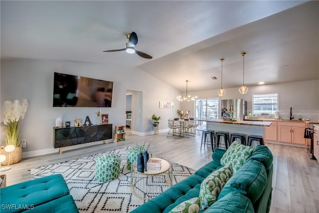 917 SW 23rd St, Cape Coral, FL 33991 - living area featuring a chandelier, ceiling fan, light wood-style floors, and lofted ceiling