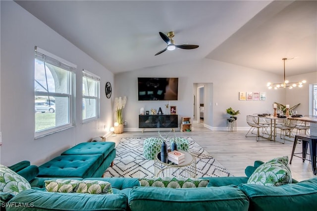 917 SW 23rd St, Cape Coral, FL 33991 - living area featuring ceiling fan, light wood-style floors, a chandelier, healthy amount of natural light, and lofted ceiling