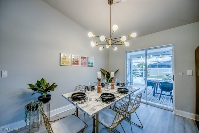 917 SW 23rd St, Cape Coral, FL 33991 - dining space with wood finished floors, a chandelier, and lofted ceiling
