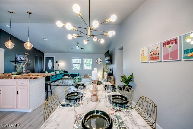 917 SW 23rd St, Cape Coral, FL 33991 - dining space with lofted ceiling, light wood-style floors, a chandelier, and ceiling fan