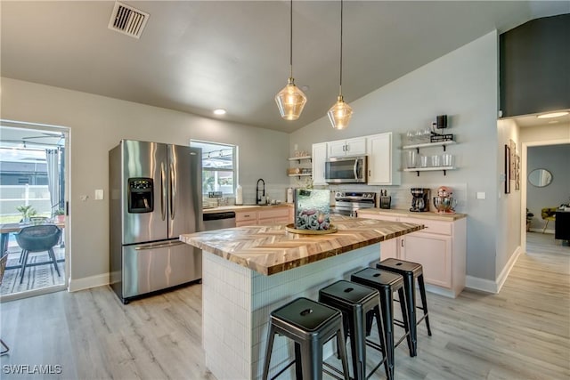 917 SW 23rd St, Cape Coral, FL 33991 - kitchen featuring stainless steel appliances, open shelves, wood counters, light wood finished floors, and vaulted ceiling