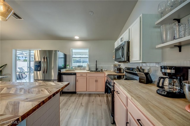 917 SW 23rd St, Cape Coral, FL 33991 - kitchen with stainless steel appliances, wooden counters, healthy amount of natural light, and light wood-style flooring