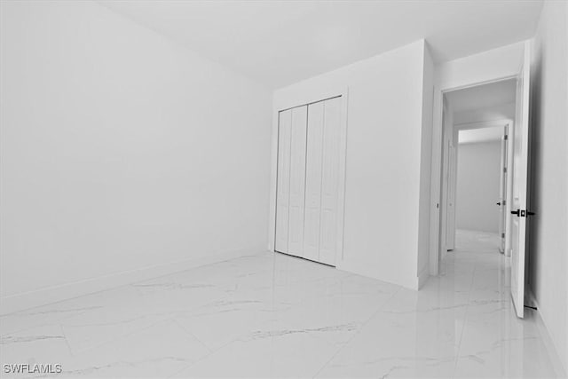 1518 Williams Ave, Lehigh Acres, FL 33972 - unfurnished bedroom with light marble finish floors and a closet