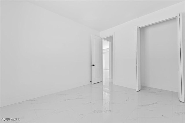 1518 Williams Ave, Lehigh Acres, FL 33972 - unfurnished bedroom with light marble finish floors and a closet