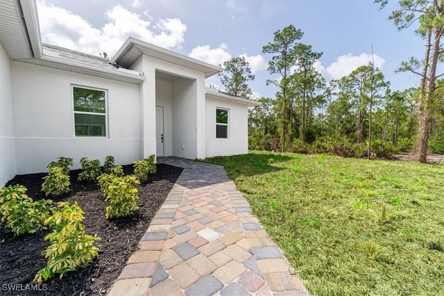 1518 Williams Ave, Lehigh Acres, FL 33972 - doorway to property with stucco siding and a lawn