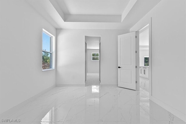 1518 Williams Ave, Lehigh Acres, FL 33972 - empty room with light marble finish floors, healthy amount of natural light, and a tray ceiling