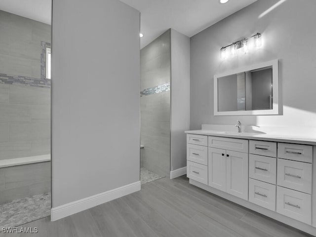 291 Rotonda Blvd S, Rotonda West, FL 33947 - bathroom featuring walk in shower, vanity, wood finished floors, and recessed lighting