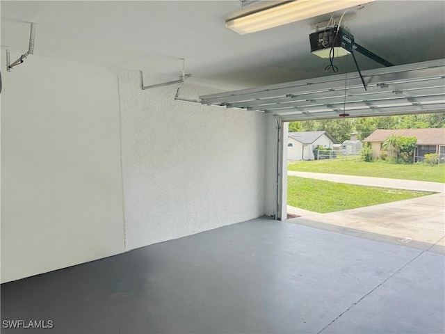 4916 7th St W, Lehigh Acres, FL 33971 - garage featuring a garage door opener and a textured wall