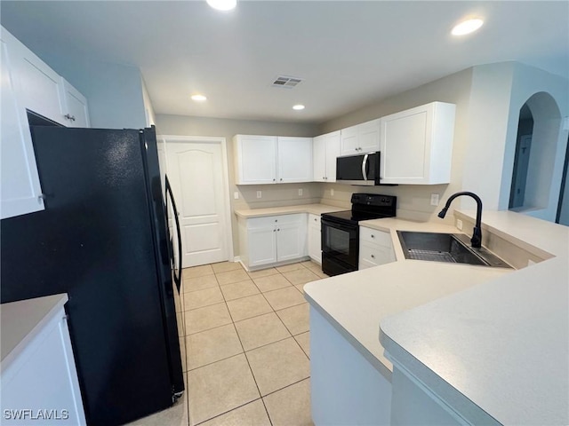 4916 7th St W, Lehigh Acres, FL 33971 - kitchen featuring black appliances, light tile patterned flooring, a peninsula, white cabinetry, and light countertops