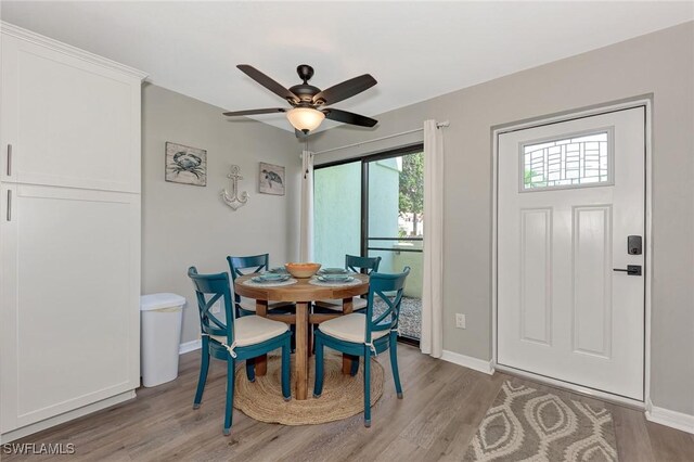 1752 Stickney Point Rd Unit 102, Sarasota, FL 34231 - dining room featuring light wood finished floors and ceiling fan