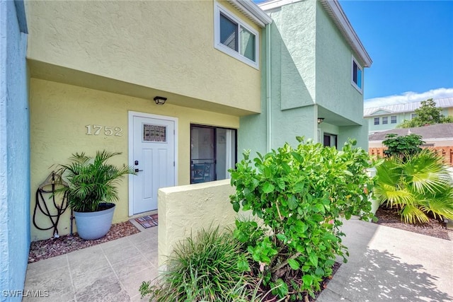 1752 Stickney Point Rd Unit 102, Sarasota, FL 34231 - doorway to property with stucco siding