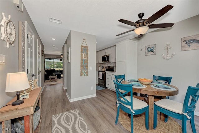 1752 Stickney Point Rd Unit 102, Sarasota, FL 34231 - dining room with ceiling fan, light wood-style flooring, and recessed lighting