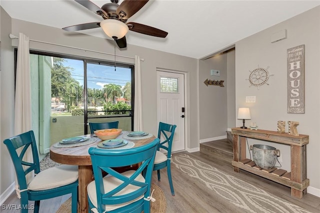 1752 Stickney Point Rd Unit 102, Sarasota, FL 34231 - dining area with wood finished floors, healthy amount of natural light, and a ceiling fan