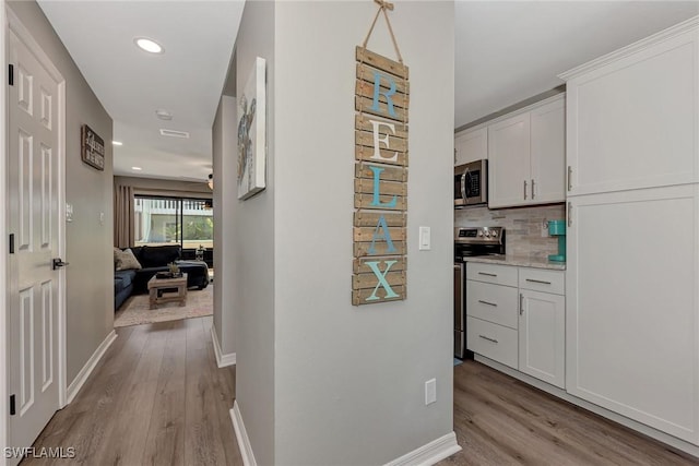 1752 Stickney Point Rd Unit 102, Sarasota, FL 34231 - hallway featuring light wood-style flooring and recessed lighting