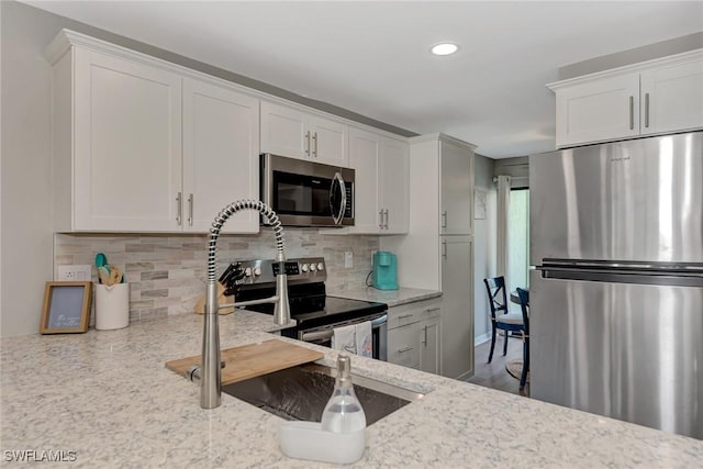1752 Stickney Point Rd Unit 102, Sarasota, FL 34231 - kitchen featuring stainless steel appliances, white cabinetry, and recessed lighting