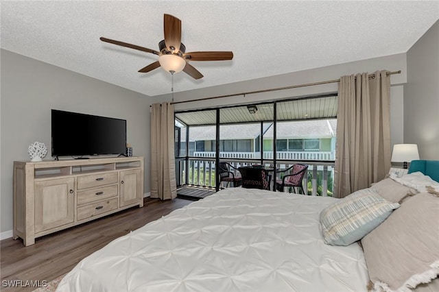 1752 Stickney Point Rd Unit 102, Sarasota, FL 34231 - bedroom with access to outside, dark wood-type flooring, a ceiling fan, and a textured ceiling
