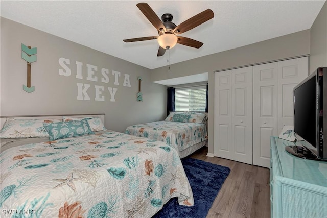 1752 Stickney Point Rd Unit 102, Sarasota, FL 34231 - bedroom with a closet, wood finished floors, and ceiling fan