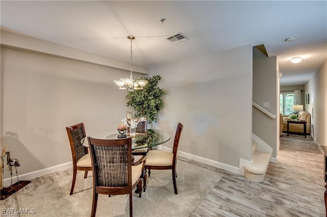 9470 Ivy Brook Run Unit 803, Fort Myers, FL 33913 - dining room featuring wood finished floors, stairs, and a chandelier