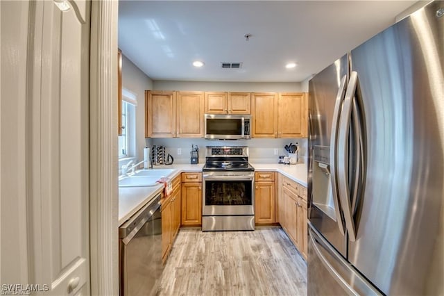 9470 Ivy Brook Run Unit 803, Fort Myers, FL 33913 - kitchen featuring appliances with stainless steel finishes, light wood-style flooring, light countertops, recessed lighting, and light brown cabinets