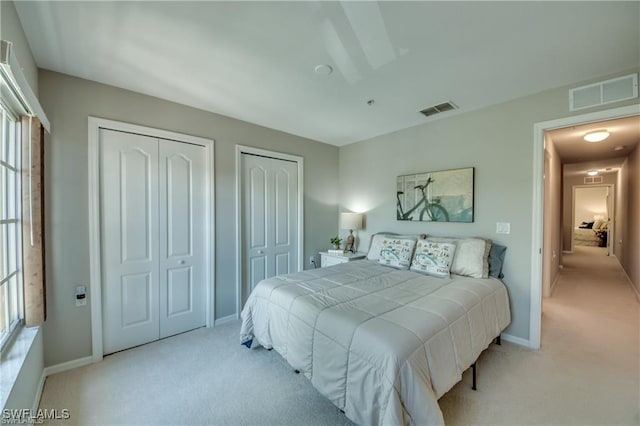 9470 Ivy Brook Run Unit 803, Fort Myers, FL 33913 - bedroom featuring multiple closets, carpet, and multiple windows