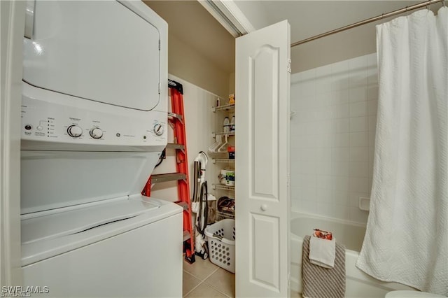 9470 Ivy Brook Run Unit 803, Fort Myers, FL 33913 - washroom featuring stacked washer and clothes dryer and light tile patterned flooring