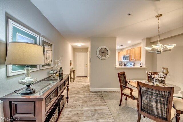 9470 Ivy Brook Run Unit 803, Fort Myers, FL 33913 - dining area featuring a chandelier and light wood-style flooring