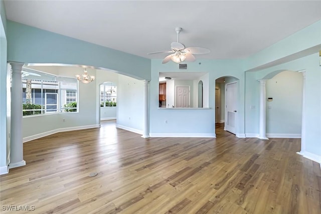 3082 Windsong Ct Unit 303, Naples, FL 34109 - unfurnished living room with a ceiling fan, wood finished floors, and arched walkways
