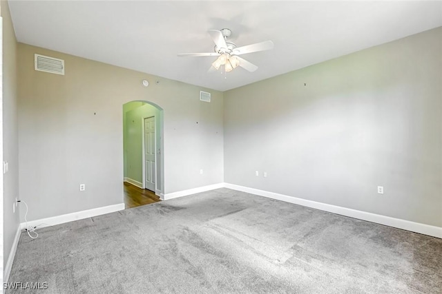3082 Windsong Ct Unit 303, Naples, FL 34109 - carpeted spare room featuring arched walkways and a ceiling fan