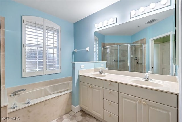3082 Windsong Ct Unit 303, Naples, FL 34109 - full bathroom with a garden tub, double vanity, a stall shower, and tile patterned flooring