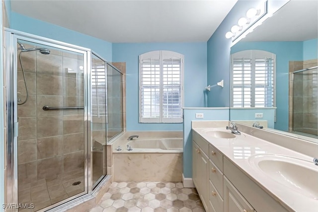 3082 Windsong Ct Unit 303, Naples, FL 34109 - bathroom featuring plenty of natural light, a garden tub, a stall shower, and double vanity