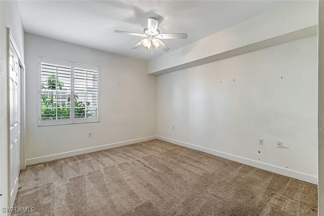 3082 Windsong Ct Unit 303, Naples, FL 34109 - empty room featuring light carpet and ceiling fan
