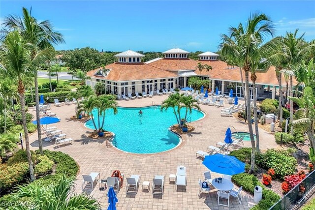 3082 Windsong Ct Unit 303, Naples, FL 34109 - community pool featuring a patio