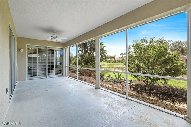 3082 Windsong Ct Unit 303, Naples, FL 34109 - unfurnished sunroom featuring ceiling fan and a water view