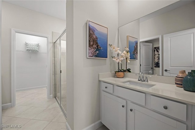 9051 Leatherwood Loop, Lehigh Acres, FL 33936 - full bath featuring a stall shower, vanity, tile patterned flooring, and a spacious closet