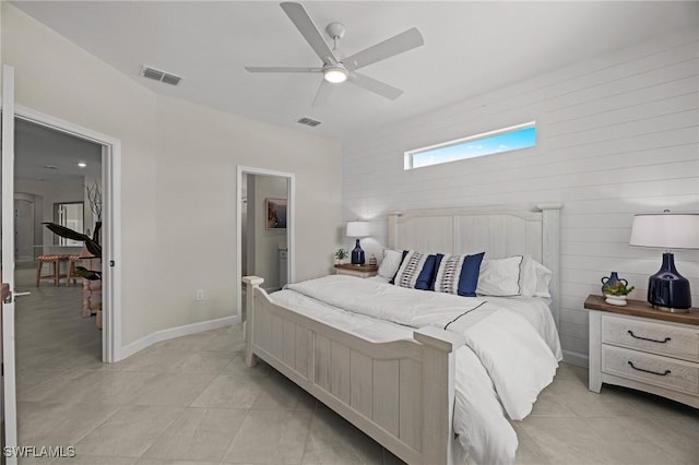 9051 Leatherwood Loop, Lehigh Acres, FL 33936 - bedroom with light tile patterned floors, a ceiling fan, and ensuite bath